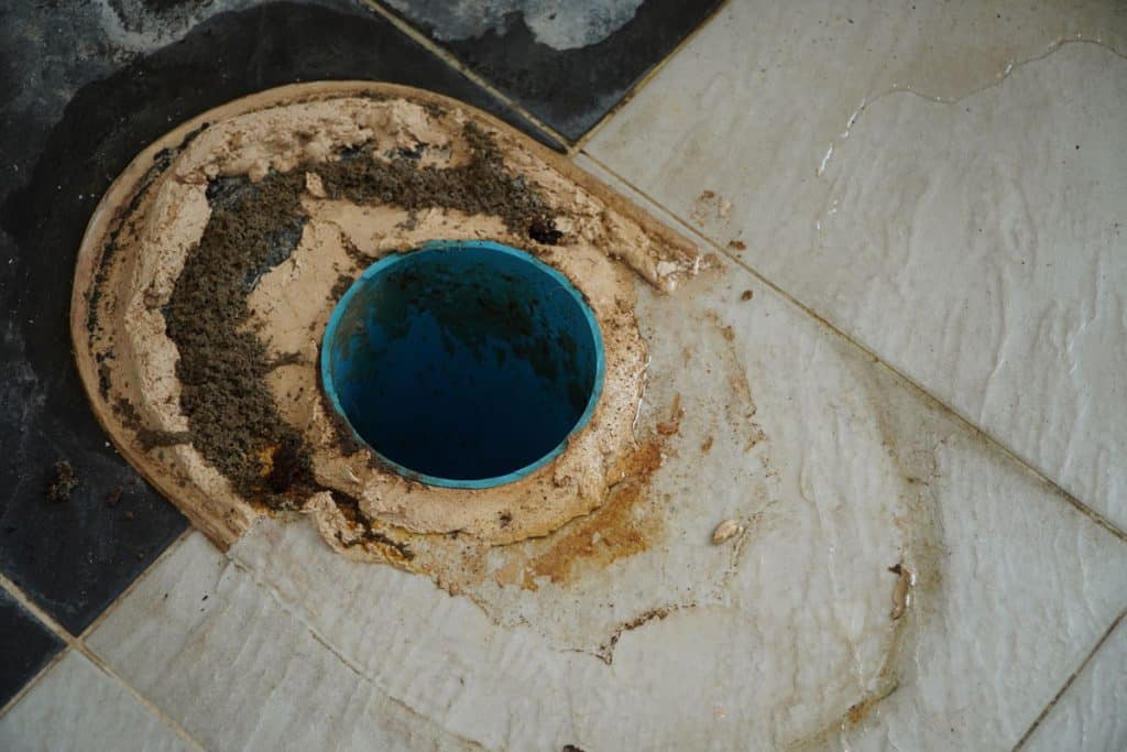 A removed toilet showing the toilet flange