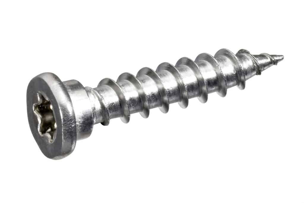 An up closed photo of a metal screw on a white background