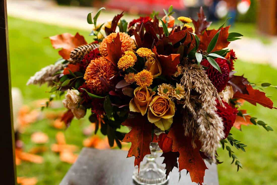 Autumnal flowers and berries in a vase