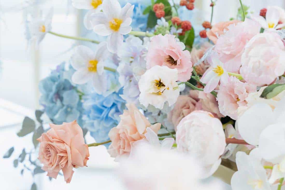 Beautiful flower composition by florist on wedding for bride and groom from roses, tulips, peonies, and orchids on the table, 15 Gorgeous Orchid Flower Arrangements
