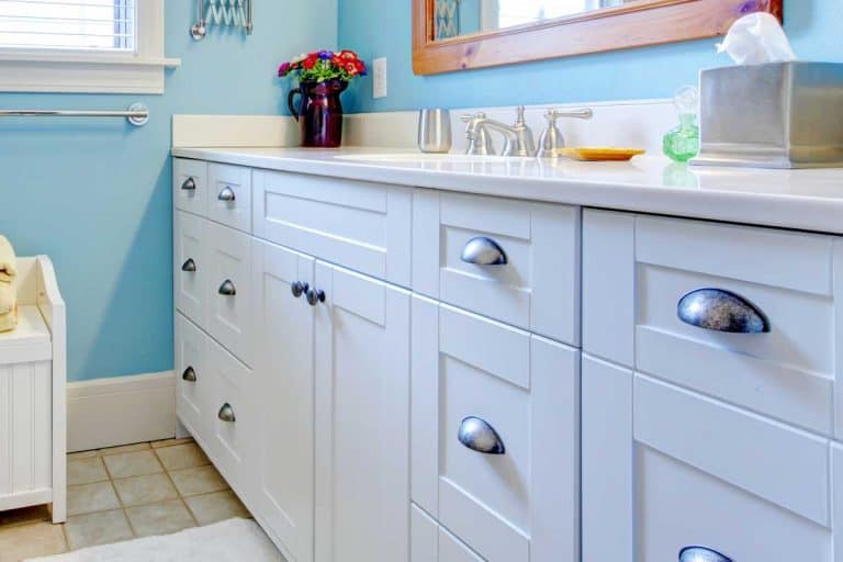 Blue and white bathroom with lots of storage space, How To Paint Laminate Bathroom Cabinets In 8 Simple Steps