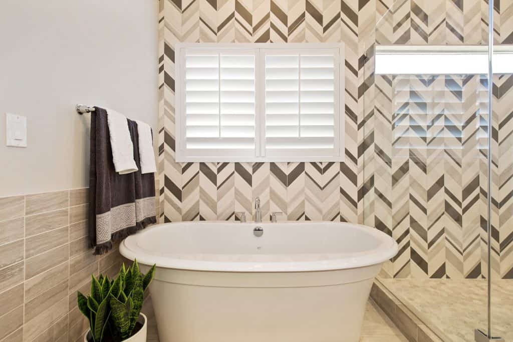 Exquisite design and detail in this lovely en suite bathroom in newly built dream home with chevron patterned walls