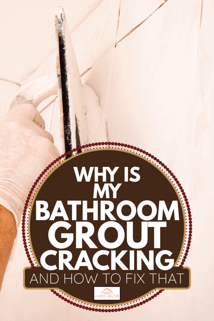 Home improvement background,close-up of a tile setters hand applying tile grout with a grout float to a new tile shower wall. Why Is My Bathroom Grout Cracking [And How To Fix That]