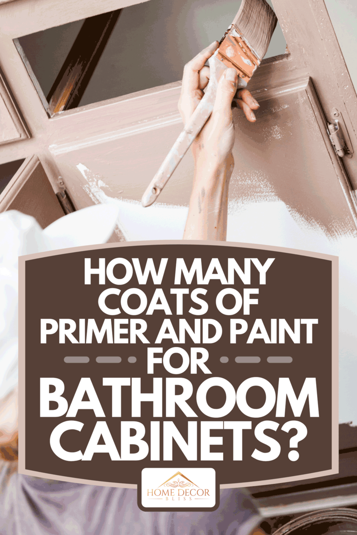 A close up of woman painting cabinets, How Many Coats Of Primer And Paint For Bathroom Cabinets?