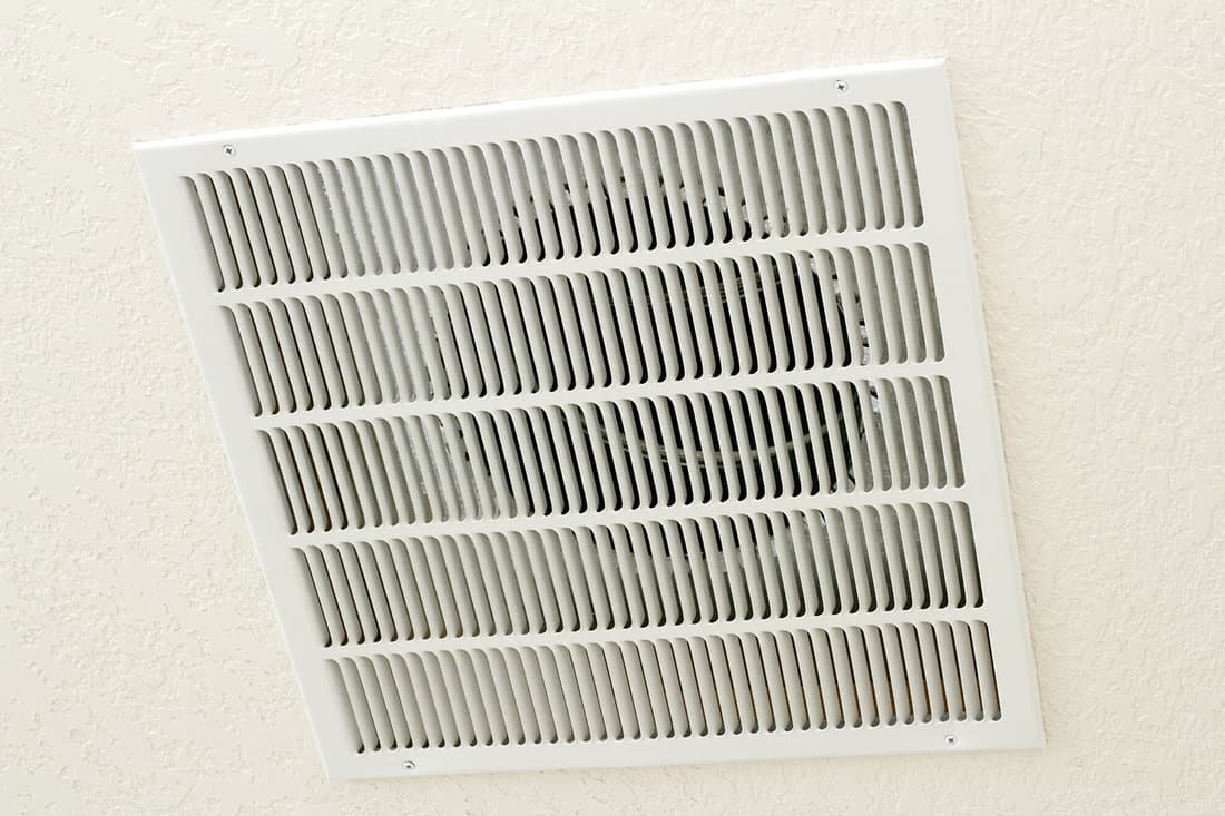 Large square white return air vent located in the ceiling of a home