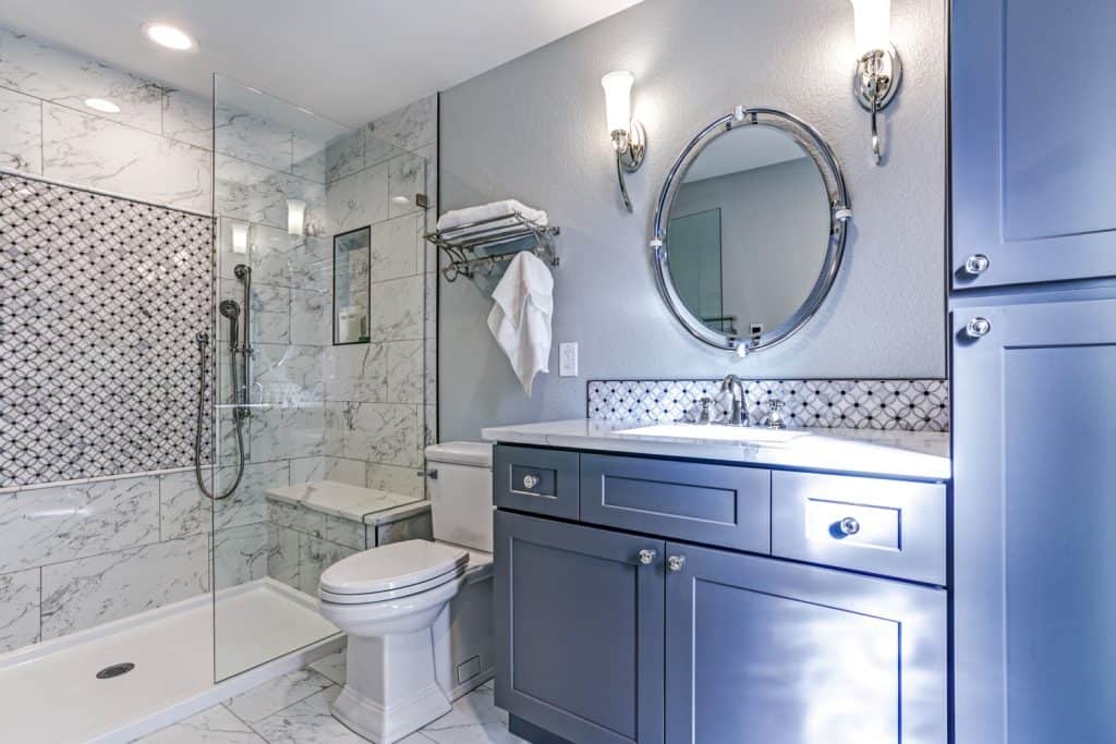 Luxury bathroom design with Marble shower Surround and mosaic accent tiles.