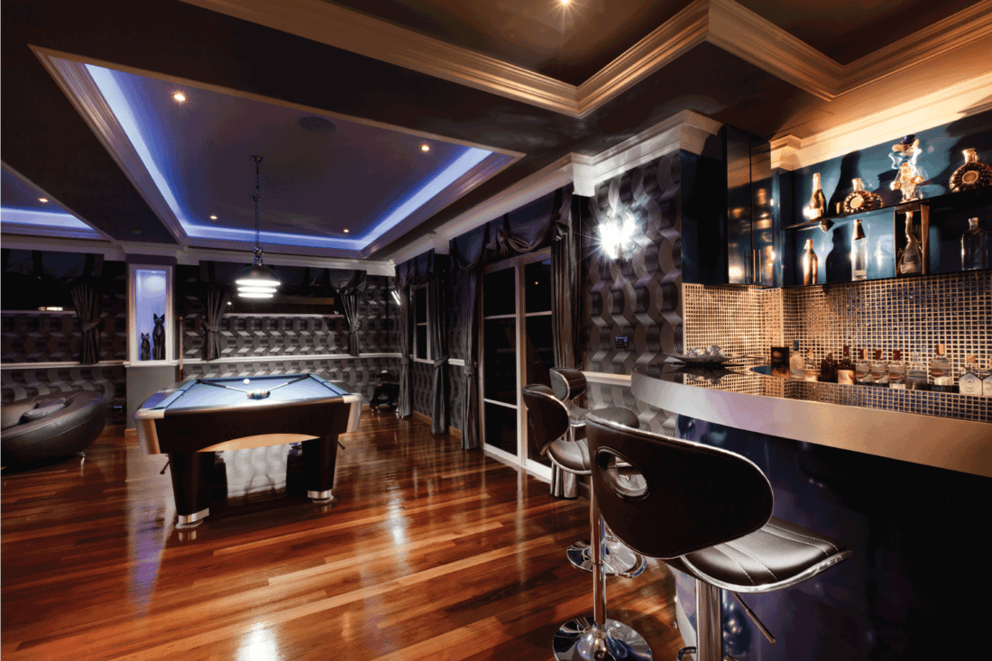 Luxury game room lounge with a bar and pool table. ultimate modern man cave