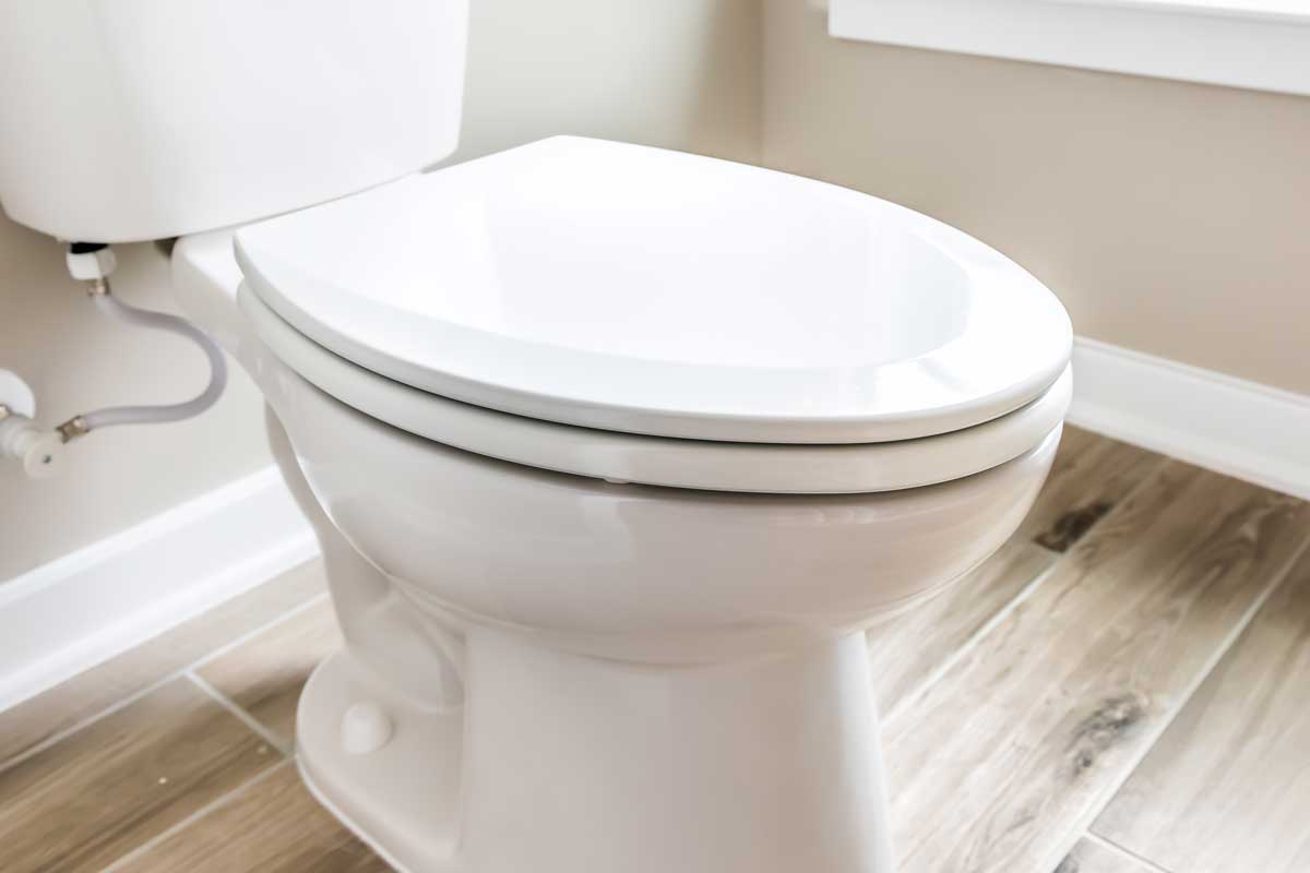 Minimalist modern clean white toilet in restroom with window in model house, How Much Does A Toilet Weigh? [Including With Water]