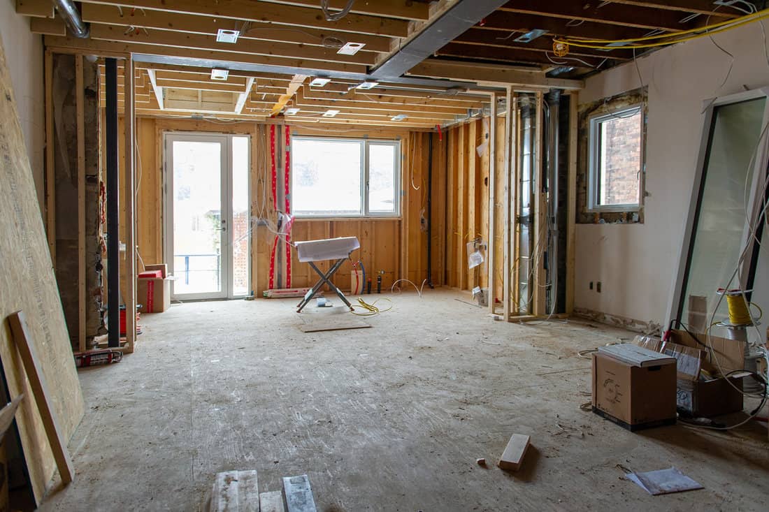 Residential construction site of a house in Toronto, Ontario- Canada. Welded steel beam is visible on the ceiling. Construction tools, material supplies and design plans. Real estate home remodeling.