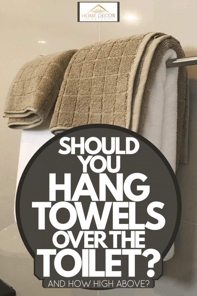 Towels hanged inside the bathroom, Should You Hang Towels Over The Toilet? [And How High Above?]
