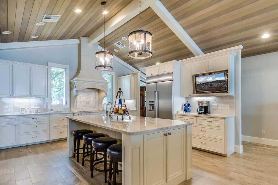 Slightly sloped wood panel ceiling in kitchen, 8 Of The Best Lighting Options For A Sloped Ceiling