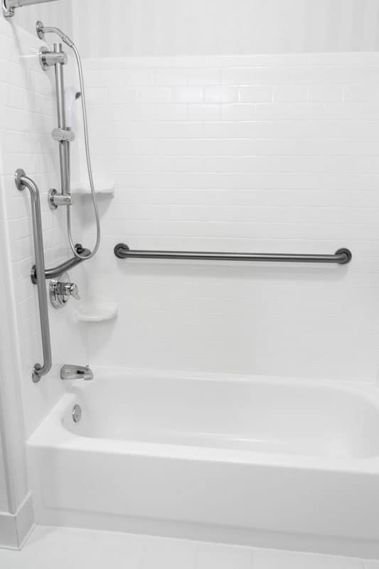 Stainlesss steel grab bar inside a bathroom with a bathtub