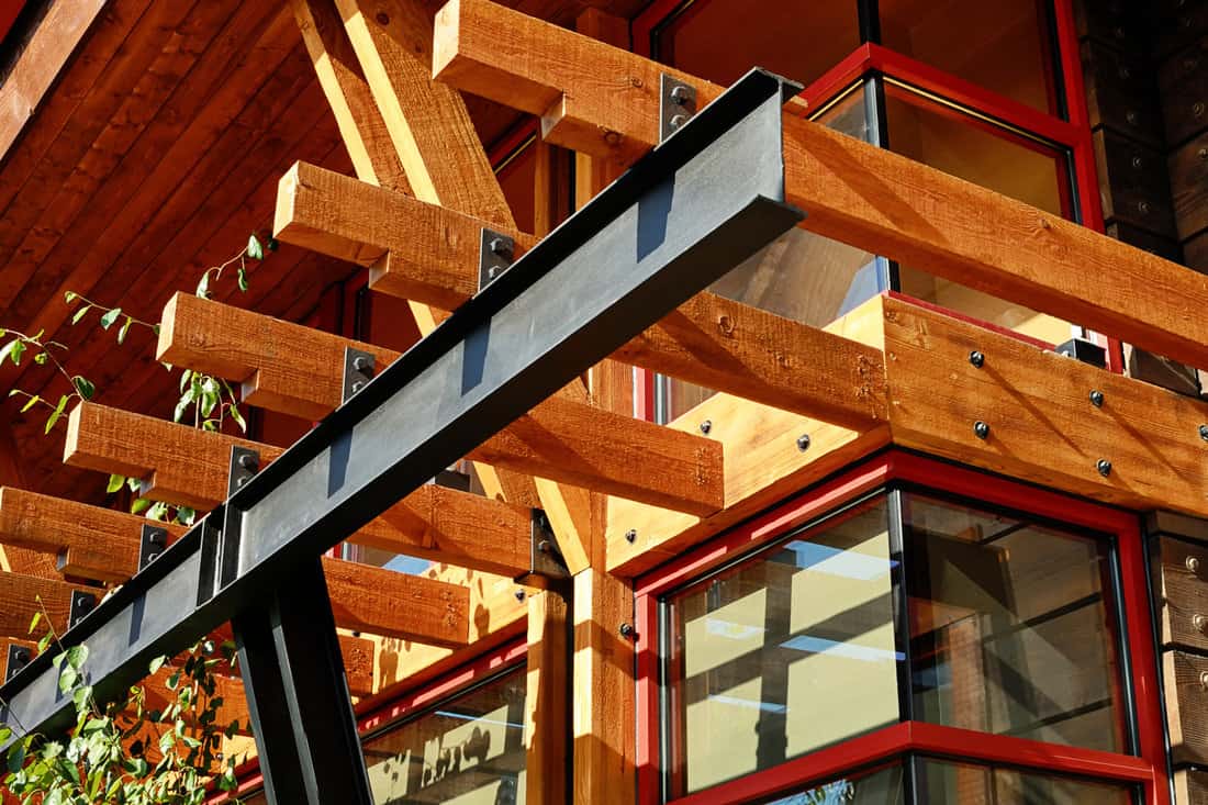 Steel I beam with exposed wood joists. 