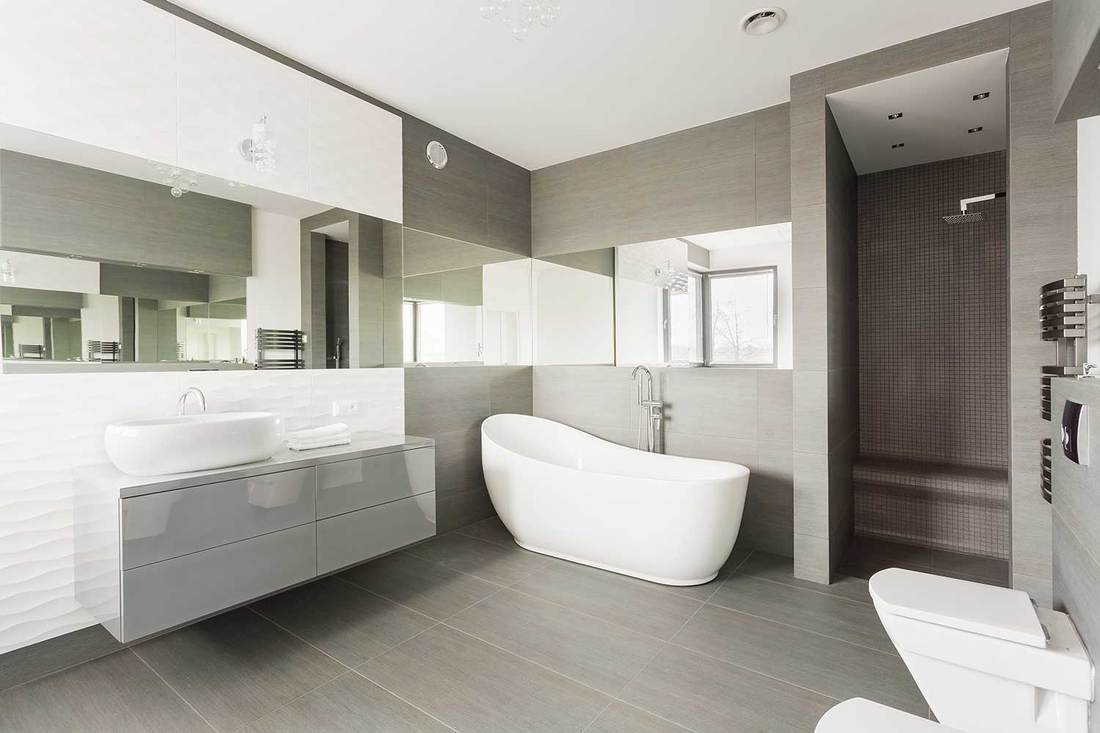White and gray exclusive big washroom with fancy bath