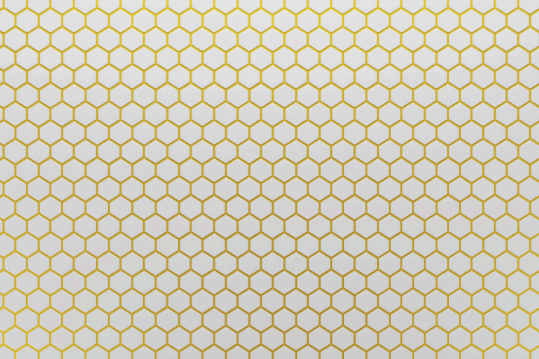 White ceramic hexagon tiles mosaic with gold grout in seams