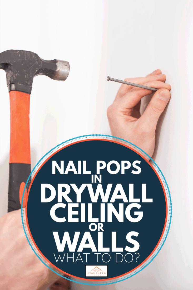 man hammeling nail unto drywall panel. Nail Pops In Drywall Ceiling Or Walls - What To Do 