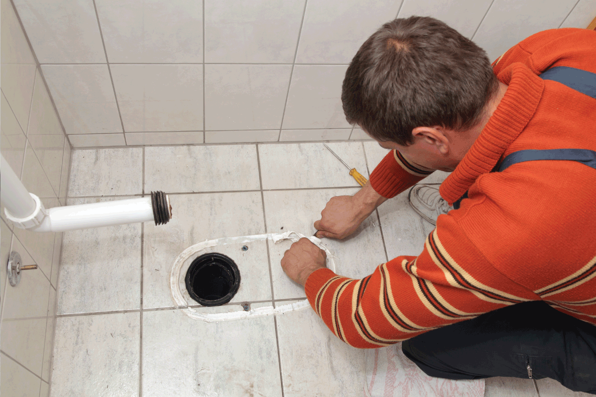 plumber removing adhesive from bathroom floor tile. Should A Toilet Flange Go On Top Of The Tile Or Be Flush With The Floor