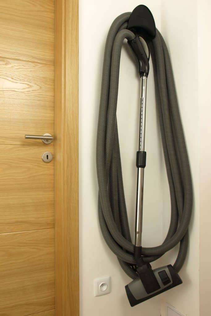 A central vacuum hose inside hanged on the wall