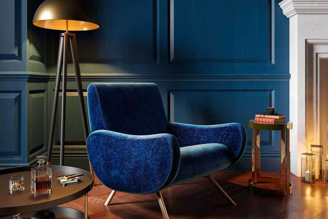 A classic royal blue color interior with armchair, fireplace, candle, floor lamp and carpet, 17 Beautiful Blue Living Room Color Schemes You Need To See