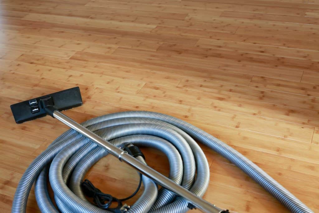 A long hose for a central vacuum system laid out on the floor, 5 Best Central Vacuum Cleaners