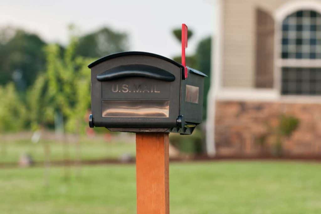 A mailbox outside of an American house, How Deep Should A Mailbox Post Be? [A Complete Guide]