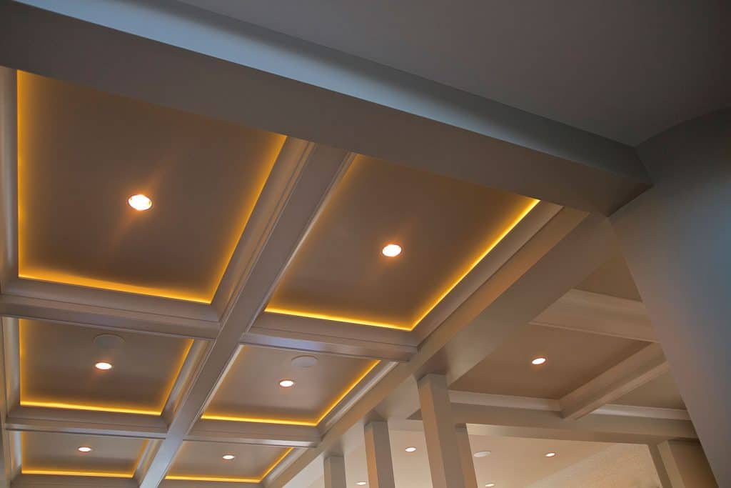 A modern recessed ceiling design with beautiful lighting layout