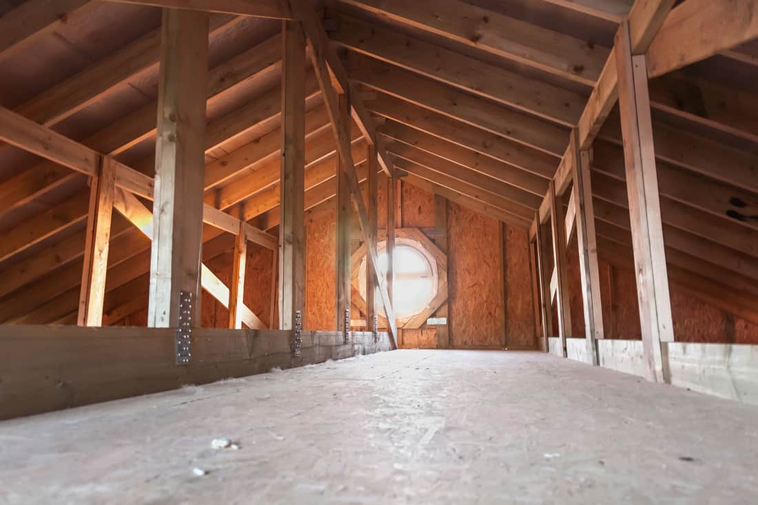 Attic with wooden beams inside a new house under construction, Do New Houses Typically Have Attics?