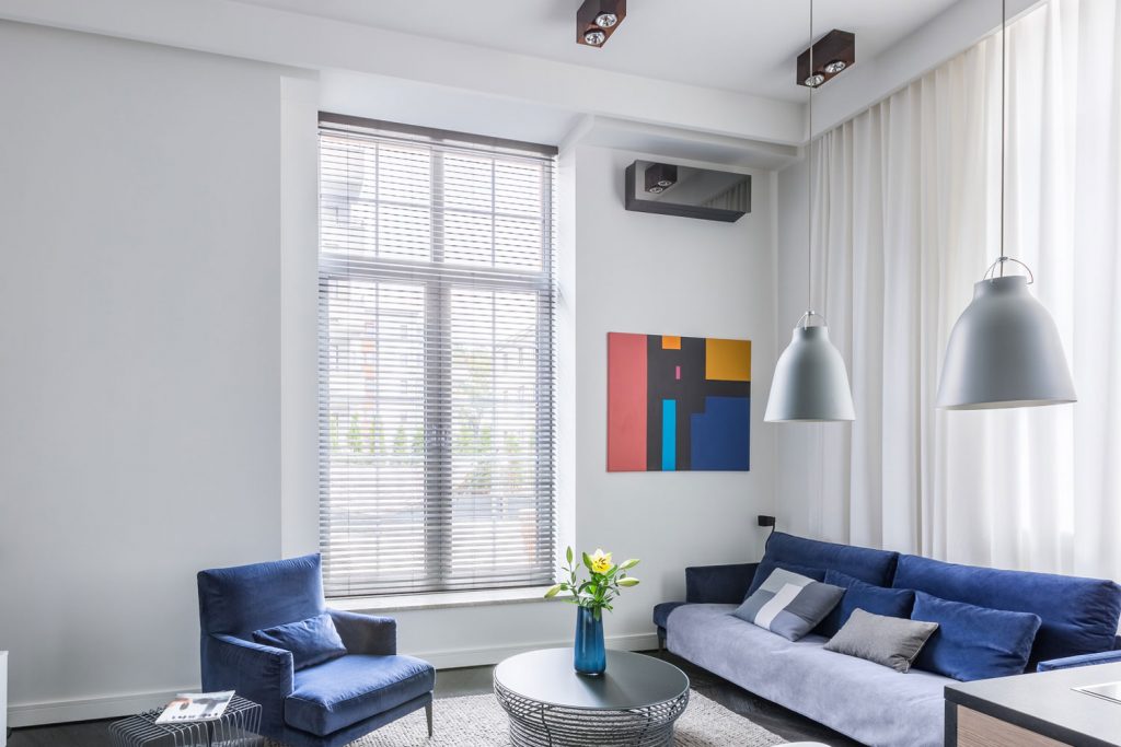 Industrial design in living room with tv and blue furniture set, blinds in grey walls, What Color Blinds Go With Grey Walls?