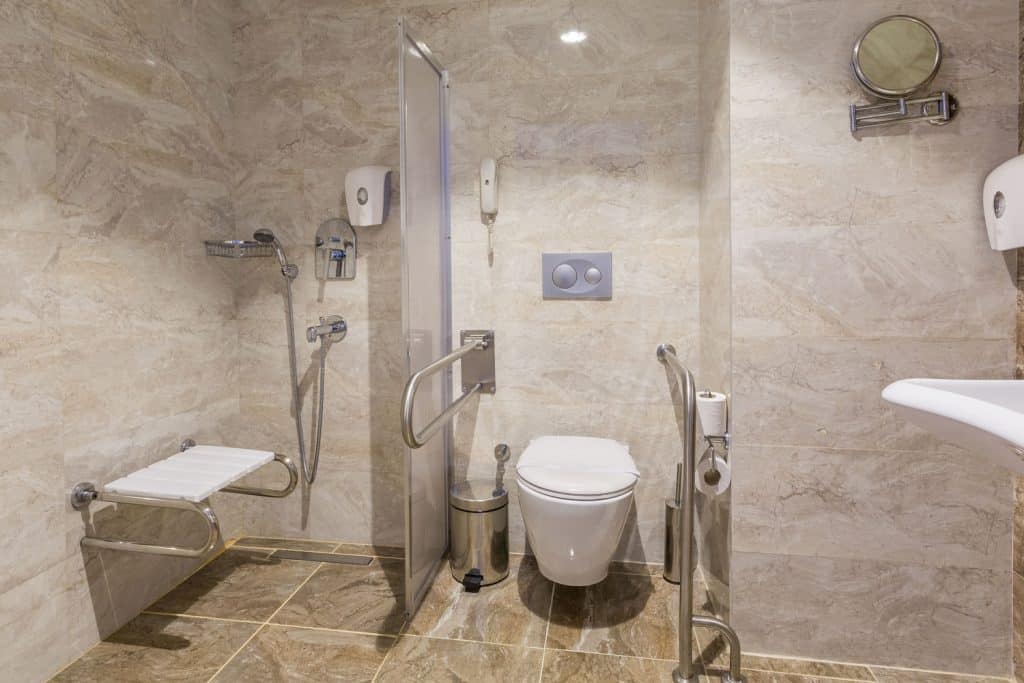 Interior of an awesome contemporary designed bathroom with toilet for PWDs