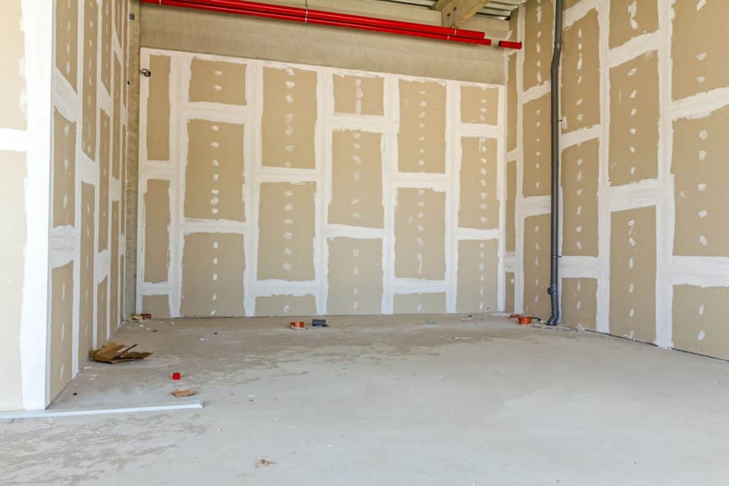 interior of an unfinished room with sealants on the drywall