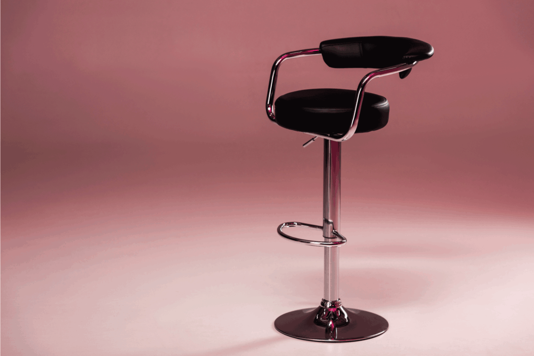 Metallic bar stool infront of pink background. Bar Stools Squeaking - What To Do