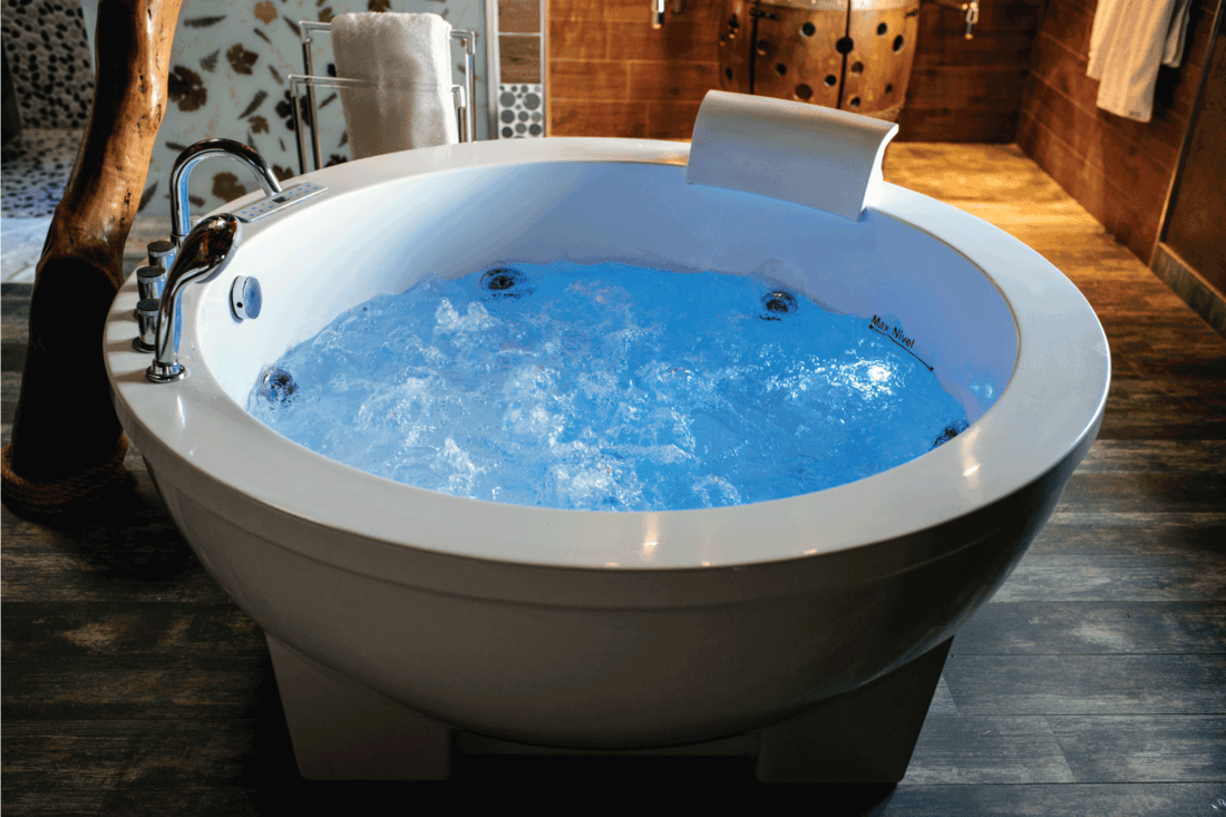 Modern beautiful hot tub with water. Round whirlpool tub