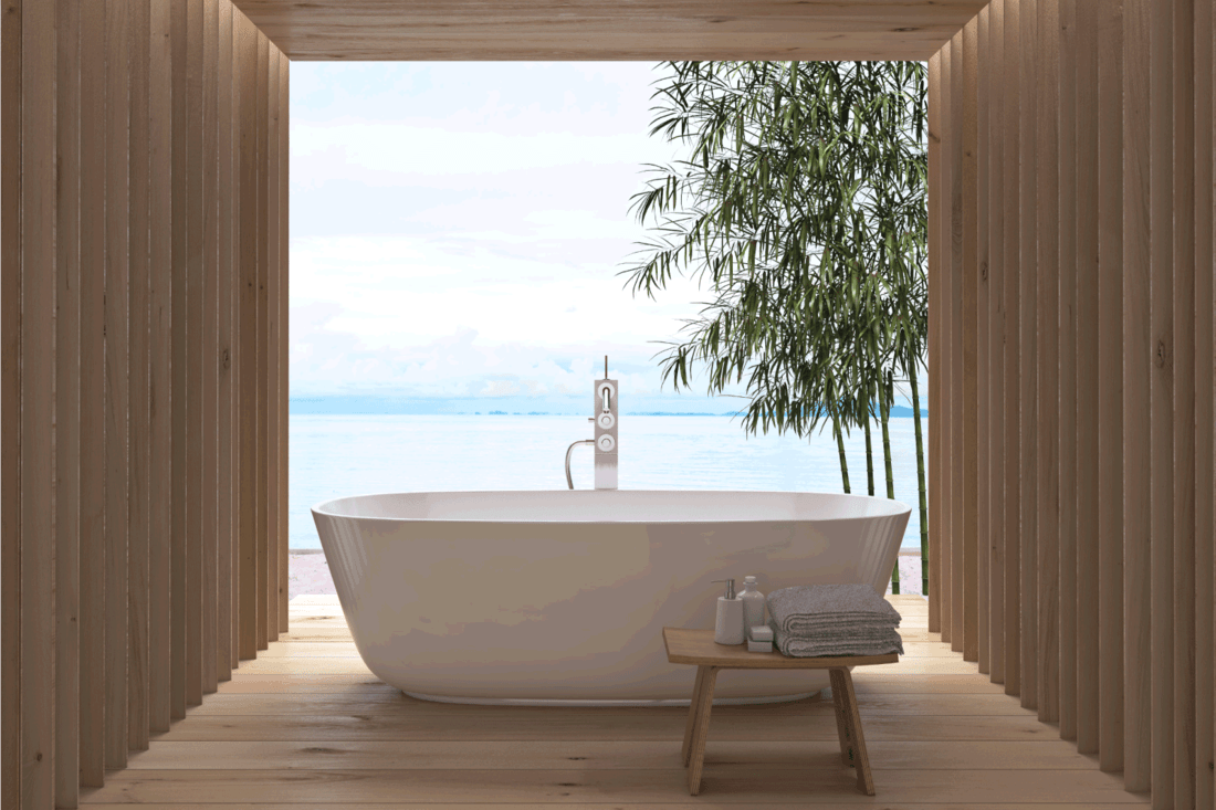 Modern luxury bathroom interior. Bathtub with a view (freestanding bathtub next to windows)