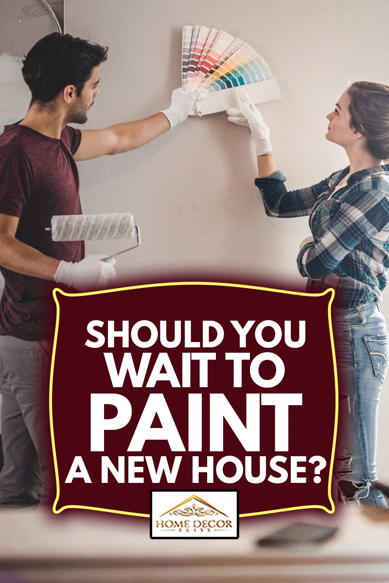 Young couple choosing the right color for their wall while renovating apartment, Should You Wait To Paint A New House?