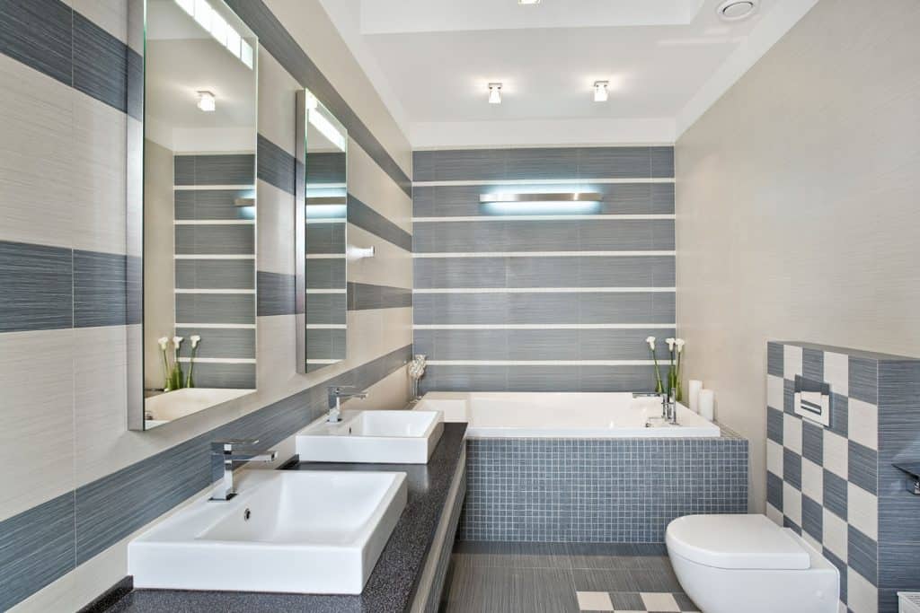 Ultra modern contemporary bathroom with white and gray stone walls and a small white backsplash