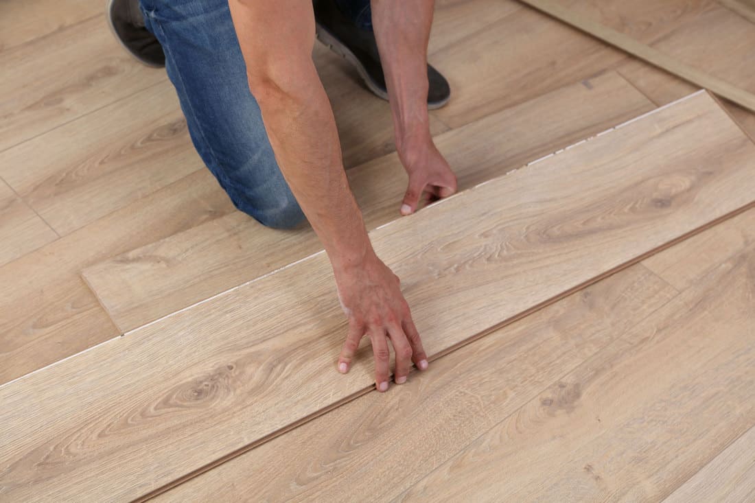 A floor installer putting wooden flooring without spacing, Should There Be Gaps In A New Hardwood Floor?