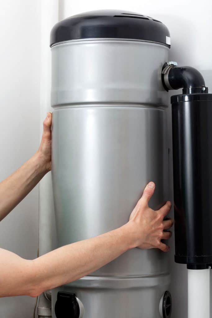 A man holding a central vacuum system