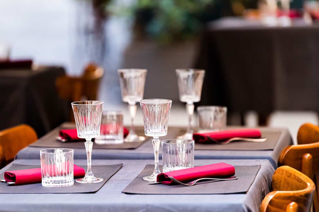 Closeup of four glasses with placemats and tablecloth, Should You Use Placemats With A Tablecloth?