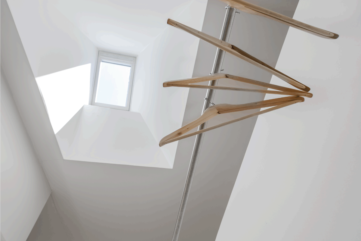 Clothes hanger under skylight. How To Make Use Of A Closet With A Sloped Ceiling
