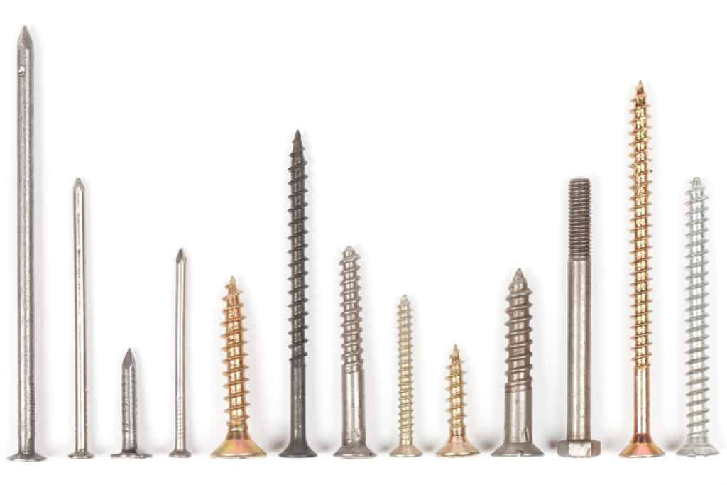 Collection of screws and nails on white. This file is cleaned, retouched