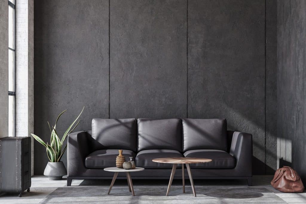 Gray leather sofa inside a black themed living room