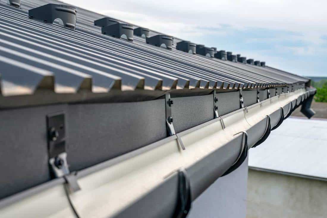 Holder gutter drainage system on the roof, What Color Gutters Go With A Black Roof?