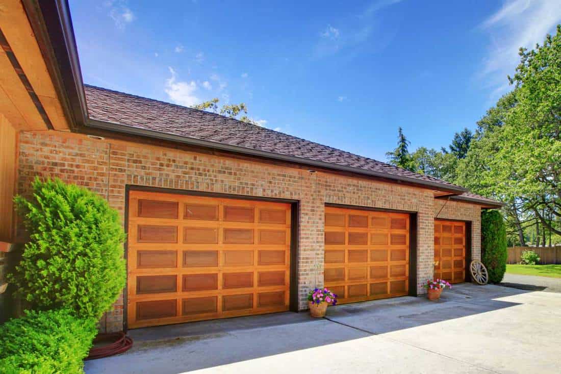 House with large three car garage with nice doors, What Color Garage Door Goes With A Tan House?