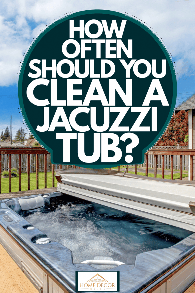 Modern jacuzzi on the backyard of a house with a gorgeous scenic skyline view, How Often Should You Clean A Jacuzzi Tub?