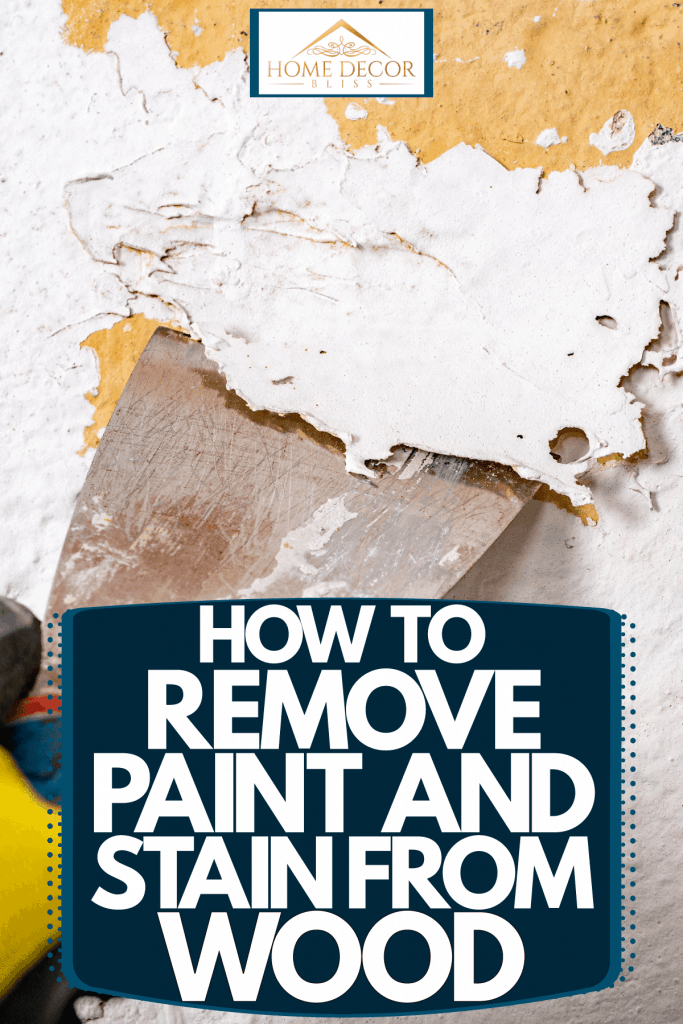 A paint expert removing pain on the wall, How To Remove Paint And Stain From Wood