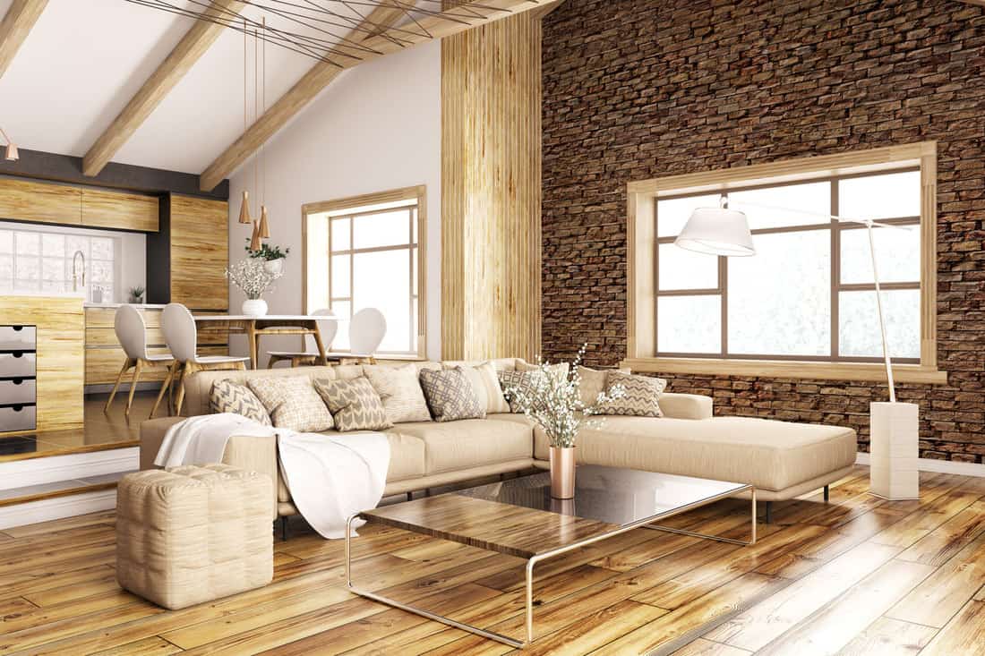 Interior of a rustic inspired living room with a huge sectional sofa, wooden flooring, and protruding wooden trusses, Can You Mix Wood And White Trim?
