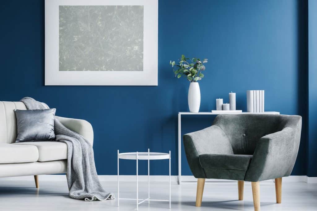 Living room with a white and gray sofa and a blue accent wall