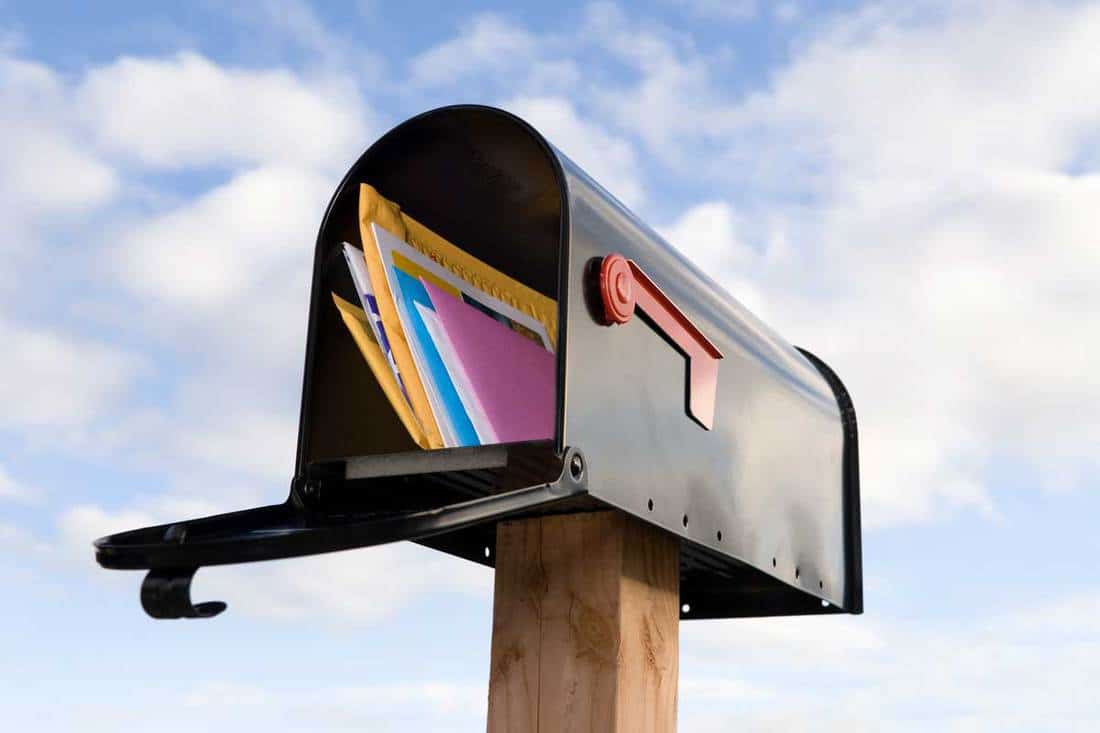 Mailbox and mail with blue sky background, How To Install A Mailbox Post [Including Without Concrete!]