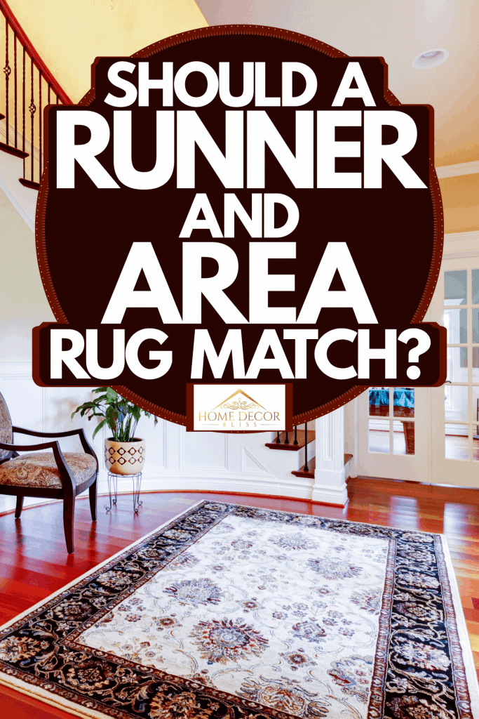 Luxurious grand foyer with wooden flooring, patterned area rug, and white painted walls, Should A Runner And Area Rug Match?