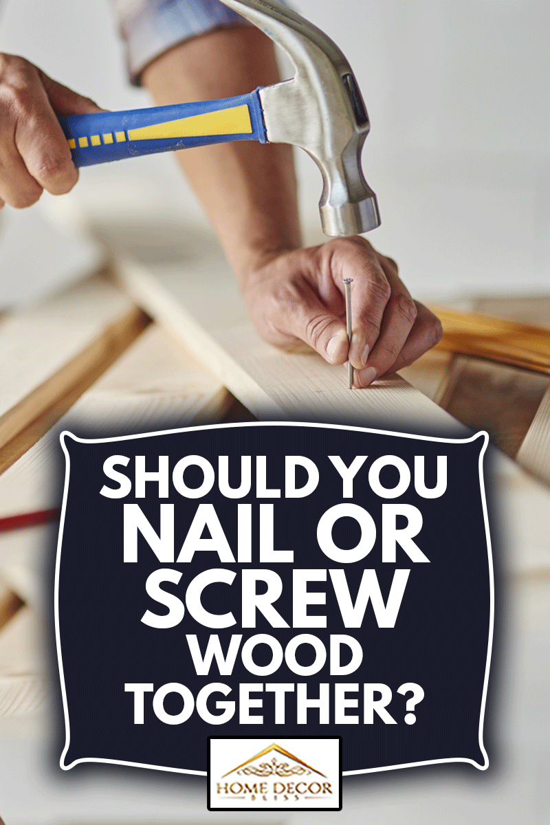 Carpenter with hammer hitting nails, Should You Nail Or Screw Wood Together?